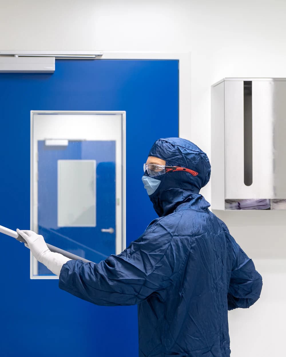 Worker in a protective suit in a pharmaceutical cleanroom.
